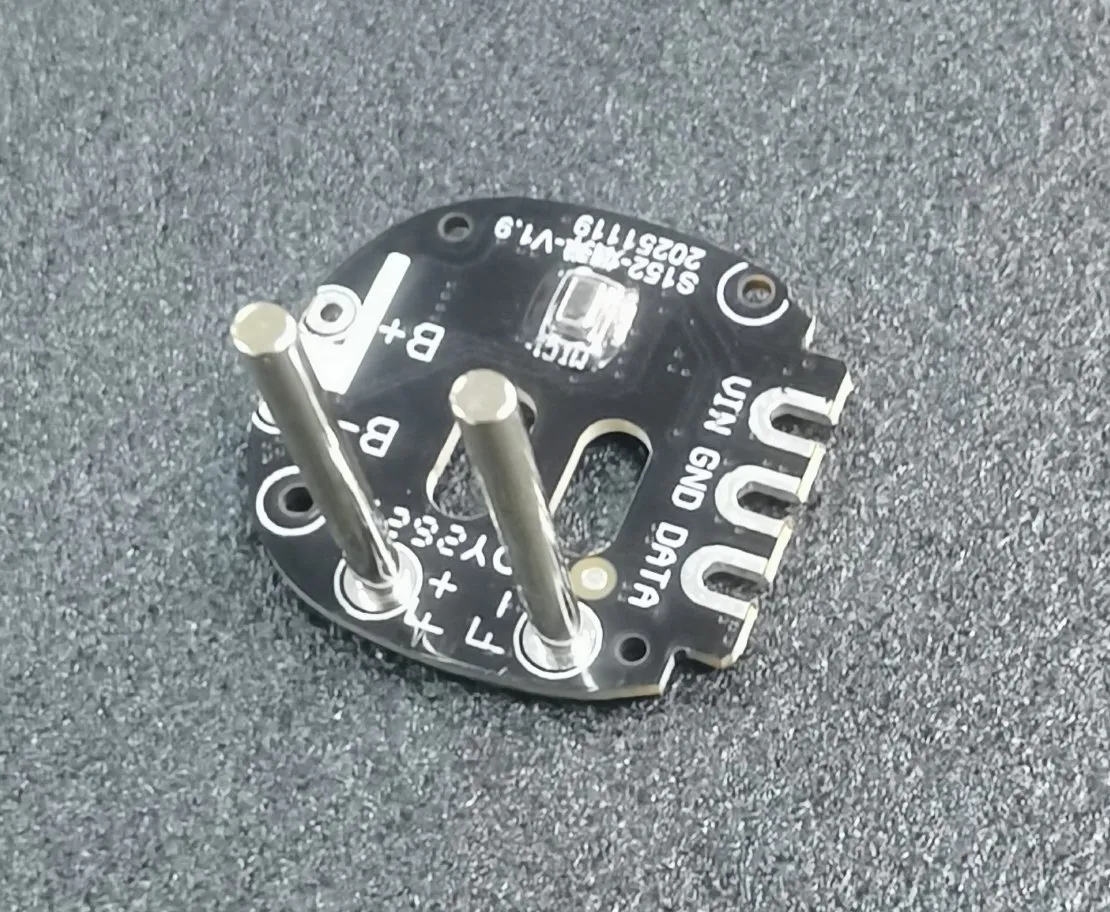 Close-up of a foger vape pod internal PCB with two electrode/charging posts. Visible contact points include B+, B-, GND, DATA, and VIN.